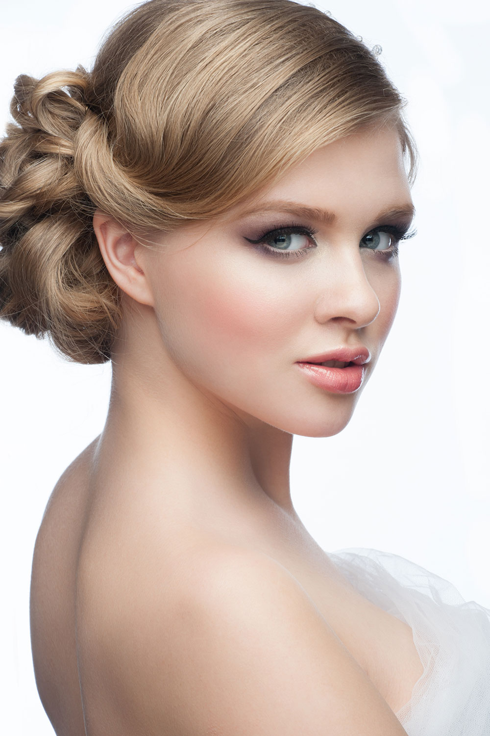 Neat side parted plaited bun Bridal hairstyle